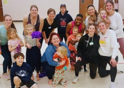 group of women with kids smiling in athletic gear