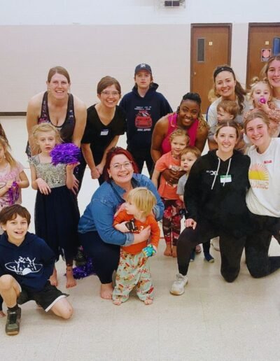 group of women with kids smiling in athletic gear