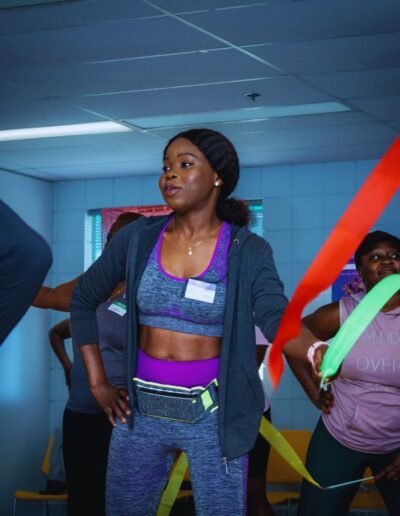 fit woman with ribbons in hands in athletic gear