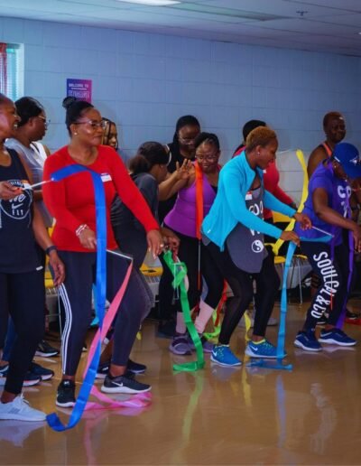 women with ribbons dancing with athletic gear on